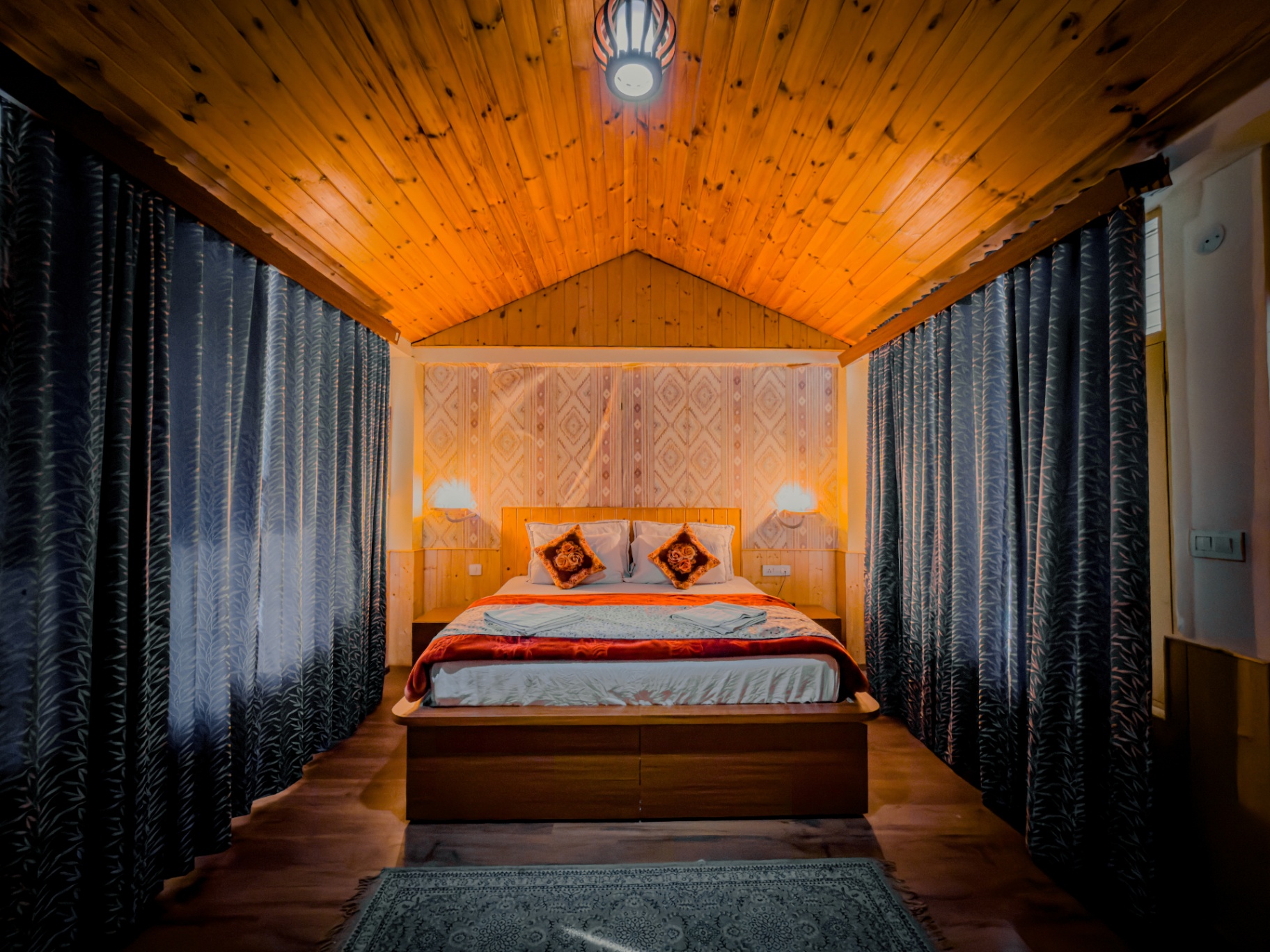 Wooden cottage bedroom with pitched ceiling